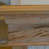 Great Room mantel detail: pecky cypress left rough on mantel body but finished on top to resist spills.