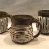 Black Raven Clay Stoneware mugs with slit exterior, white glaze
