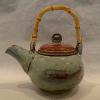 Stoneware teapot with cane handle.