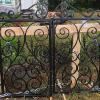 Pair of wrought iron gates painted gloss black.
