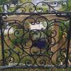 Single wrought iron gate painted hammered black.