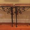 Matched pair of wrought iron rose consoles with walnut tops.