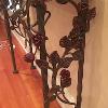 Side view of wrought iron rose console.
