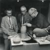 Hamada, Bernard Leach and Soetsu Yanagi (a philosopher who adopted many of the thoughts of William Morris in his development of the ideas of the "mingei" or folk craft movement in Japan).  Picture taken in the United States, probably Hawaii, in 1952.  Hamada is trimming the foot of a vase.